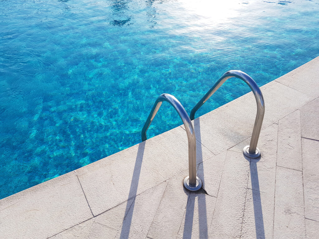 Ladder of the swimming pool cast a shadow